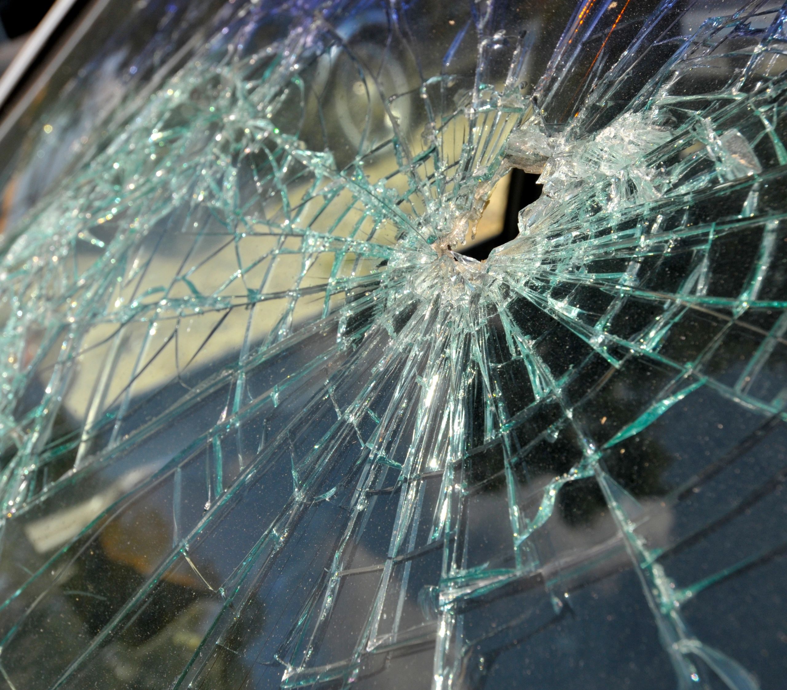 Cracked car windshield, a broken vehicle windshield being repaired by Juste's Glass
