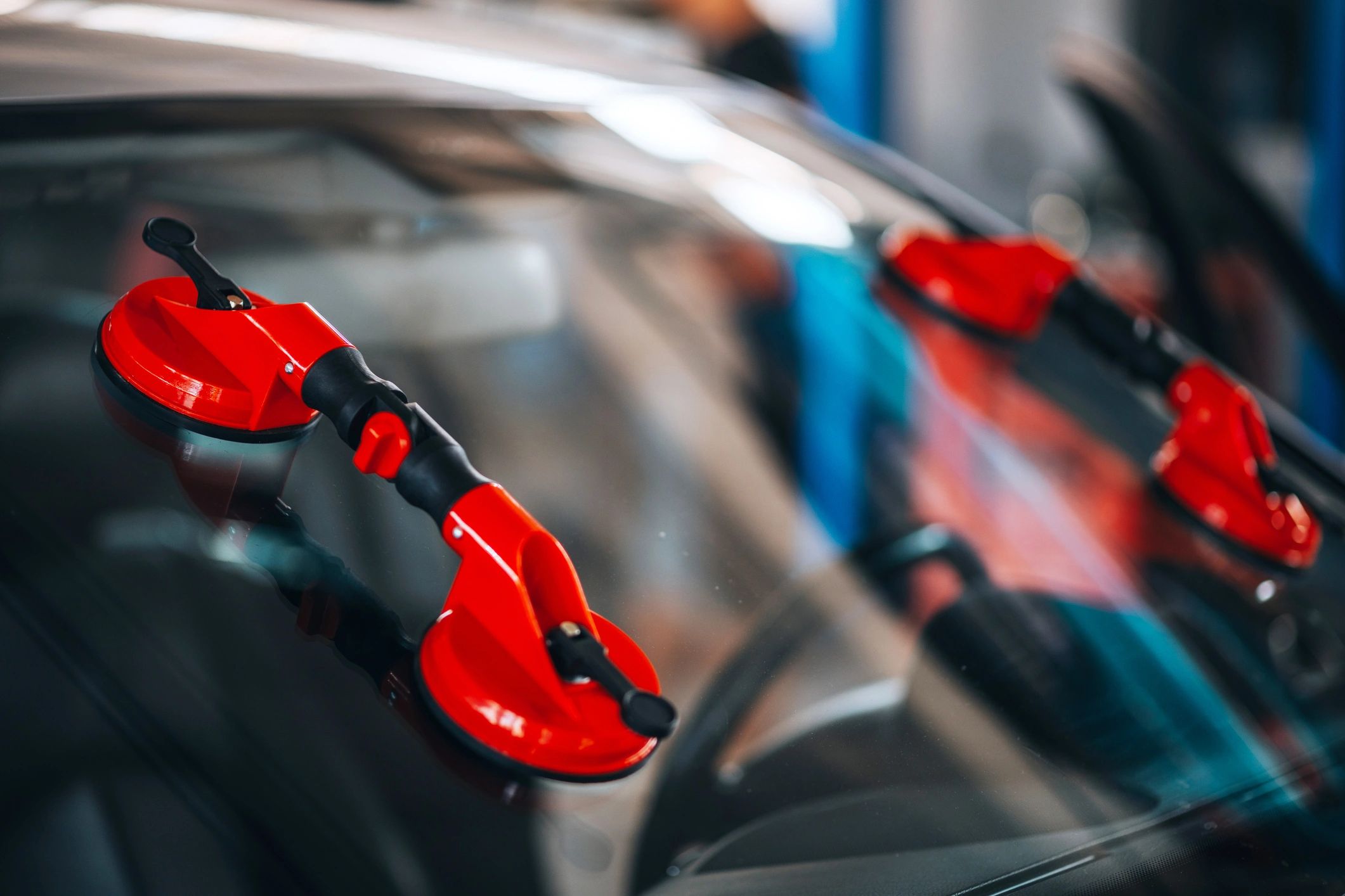 A technician at Juste's Glass completing a windshield replacement auto glass job on a Corvette in Atlanta, GA